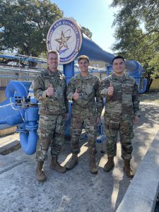 Oscar Ibanez '21 with two other airmen in front of the National Aerothermo Lab