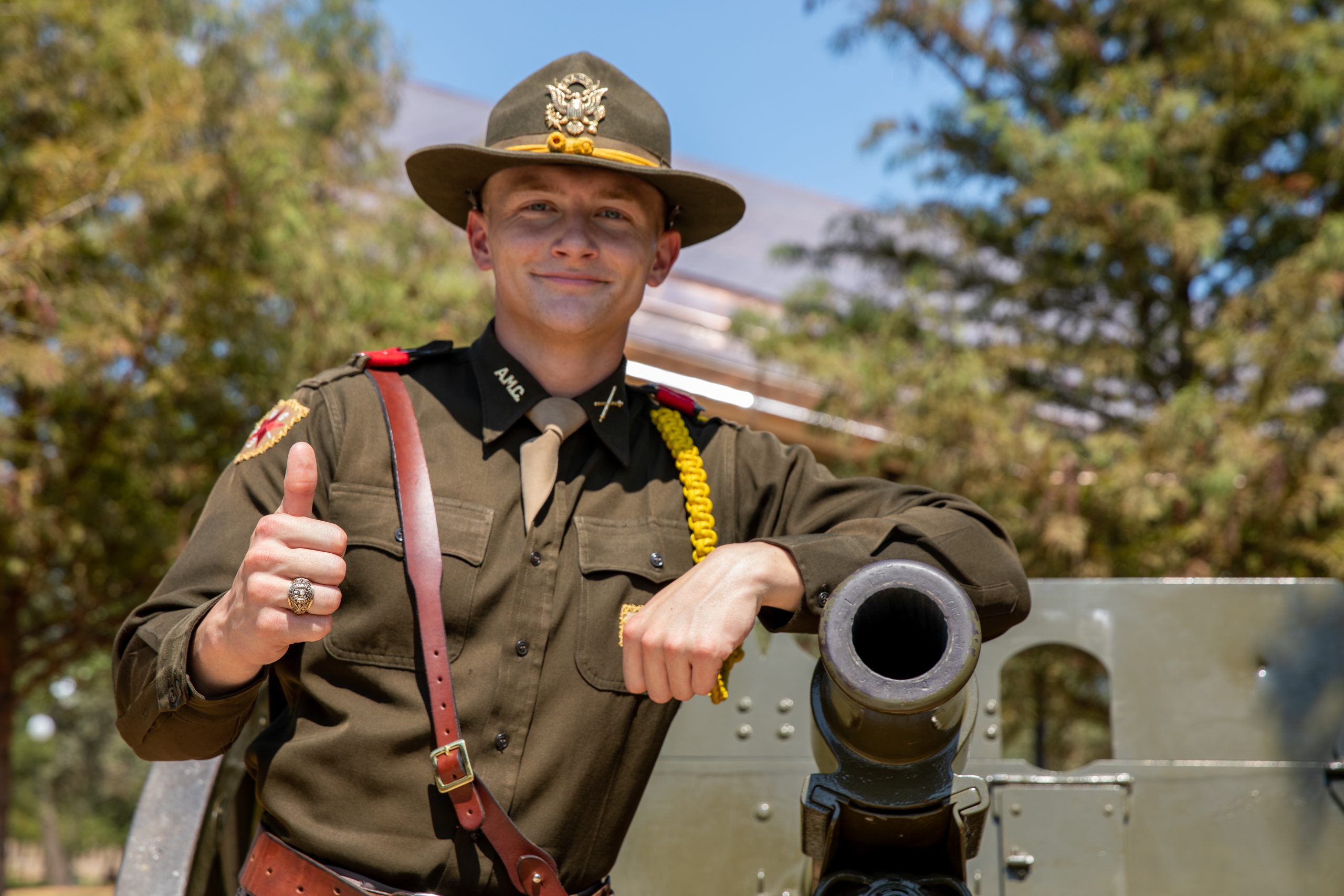 Cole Swinnea poses next to cannon