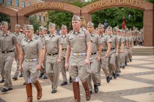 Cadet Liam Stevens '23 marches through the arches of the Quad on gameday