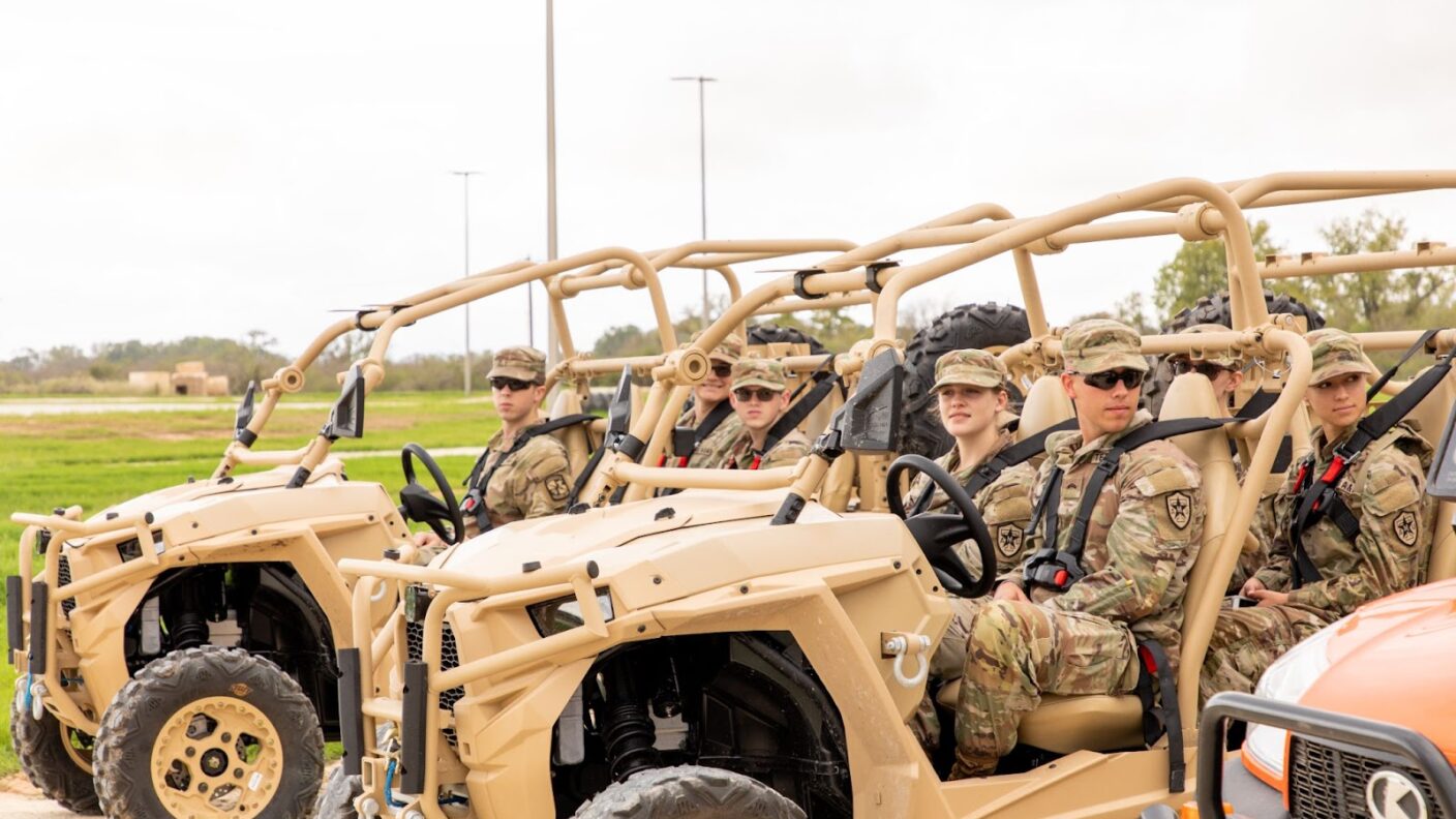 Cadets riding in off road vehicles.