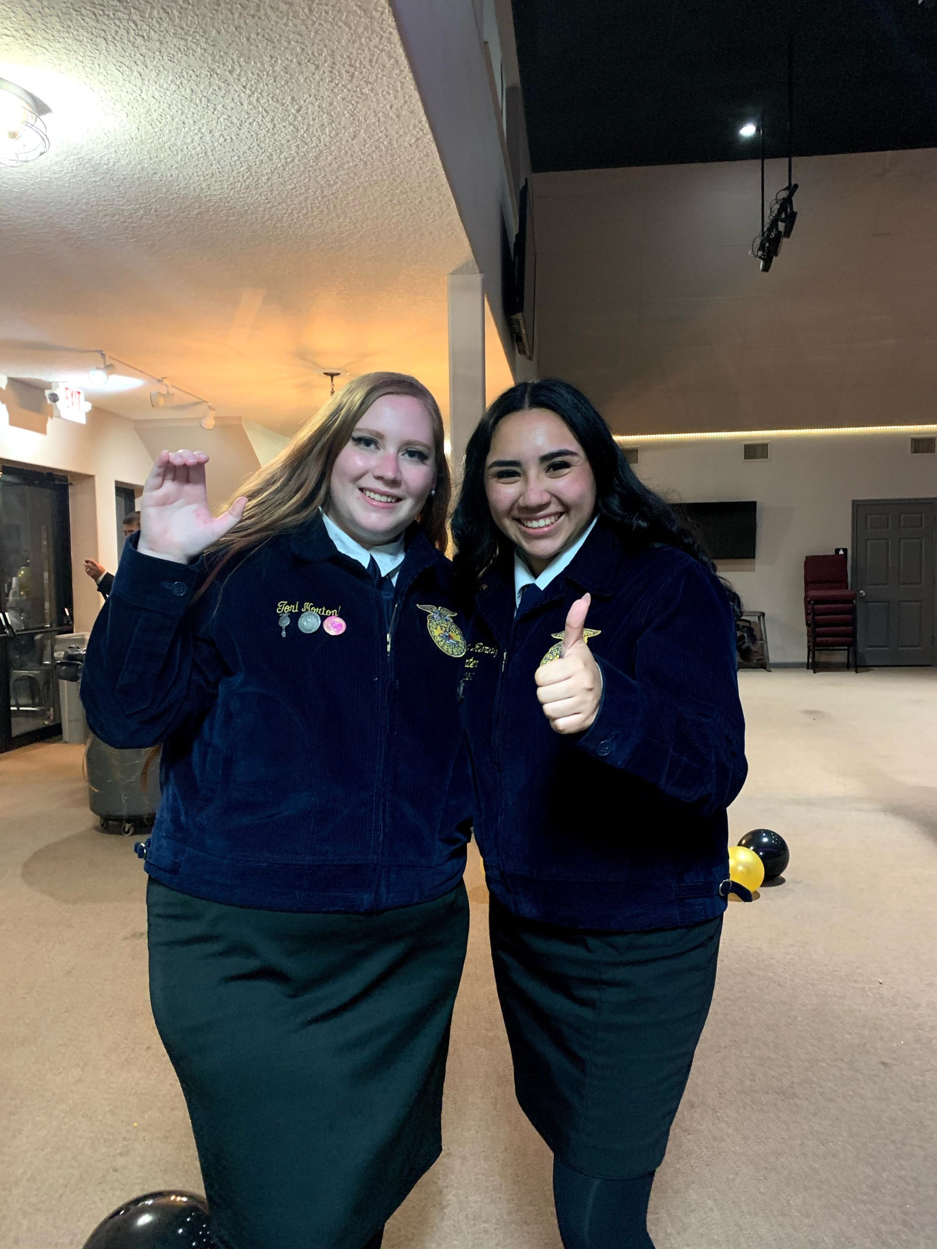 Two girls smiling for a photo.