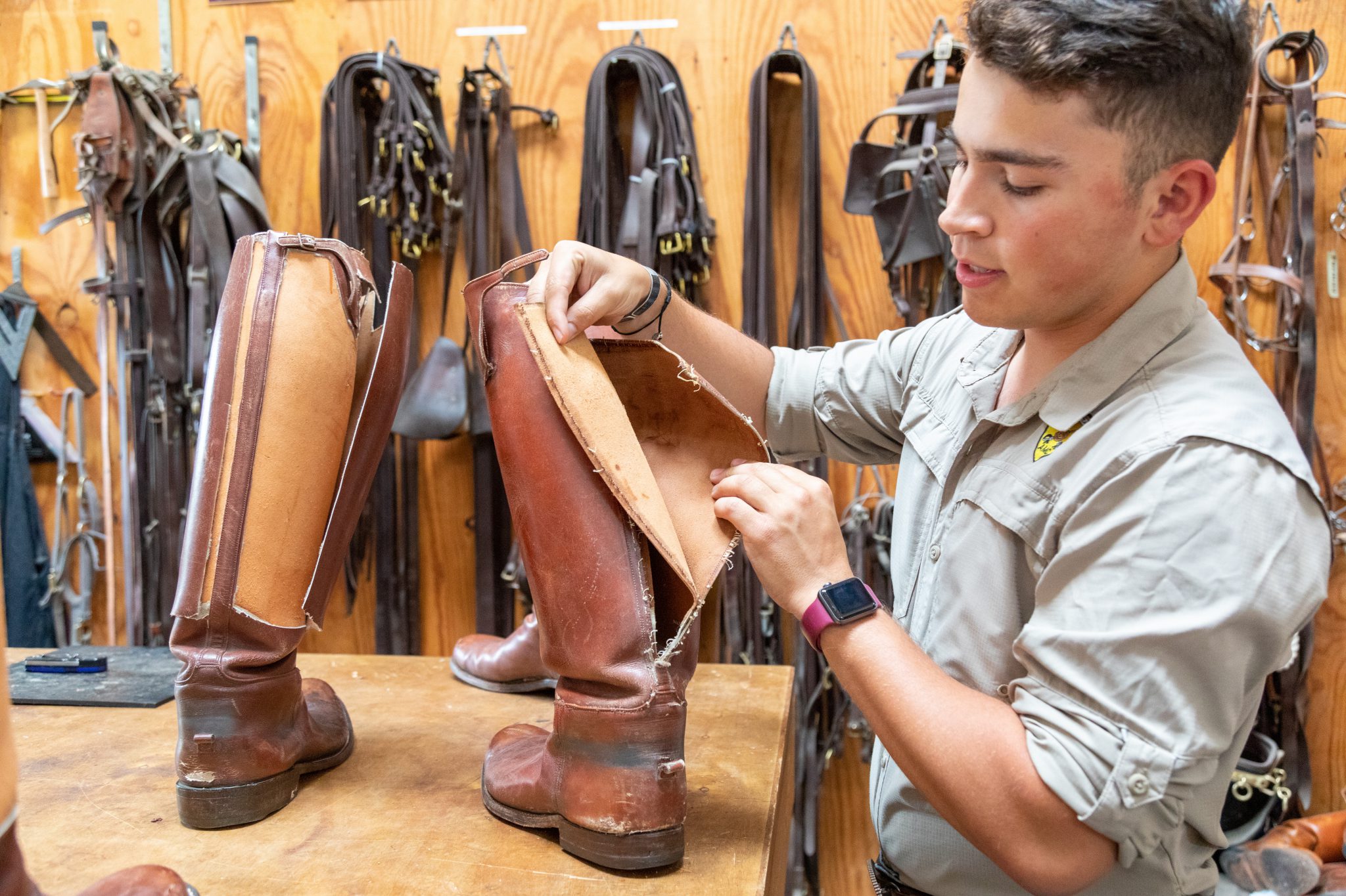 A cadet showing a boot torn apart.