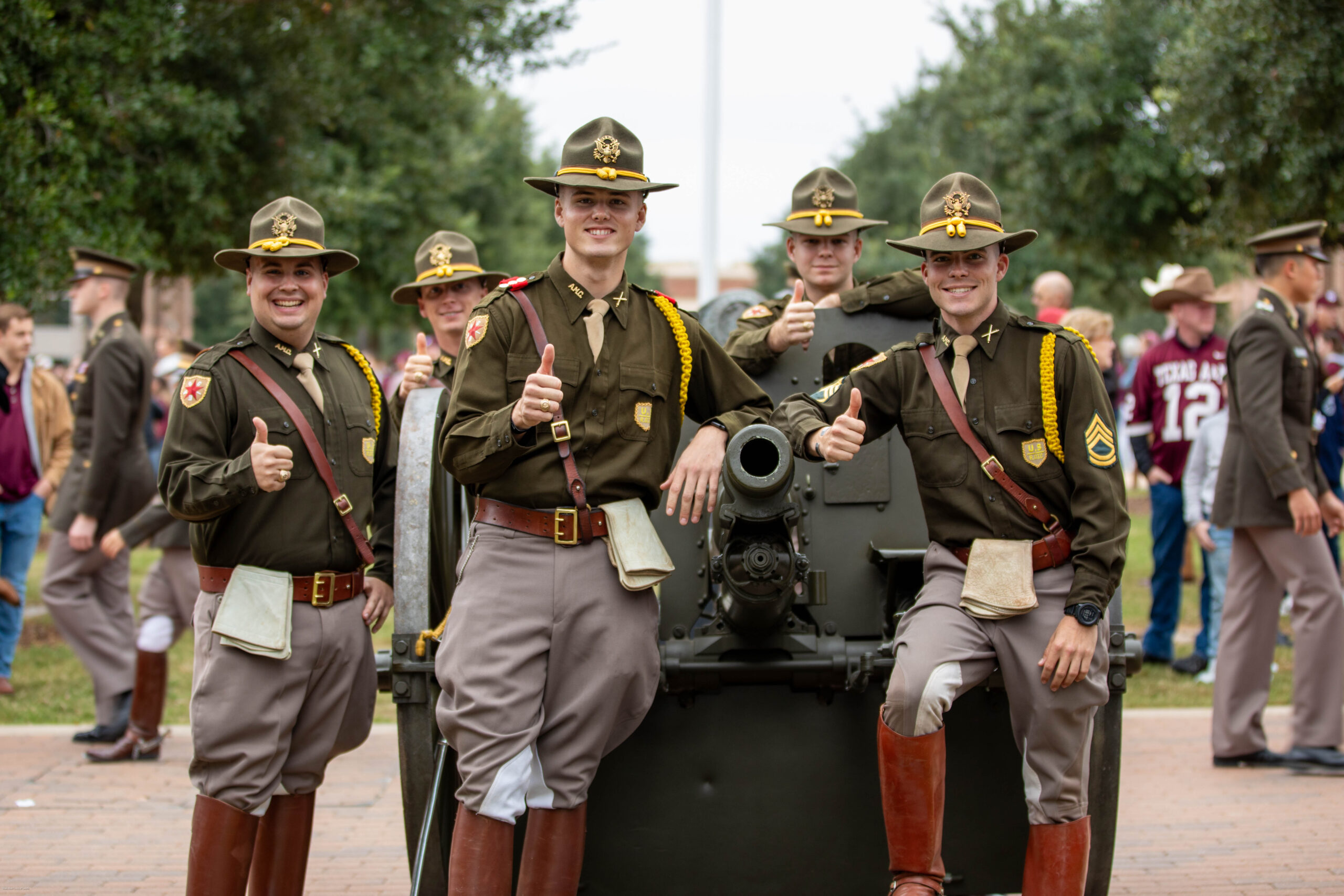 Cadet members posing around a cannon.