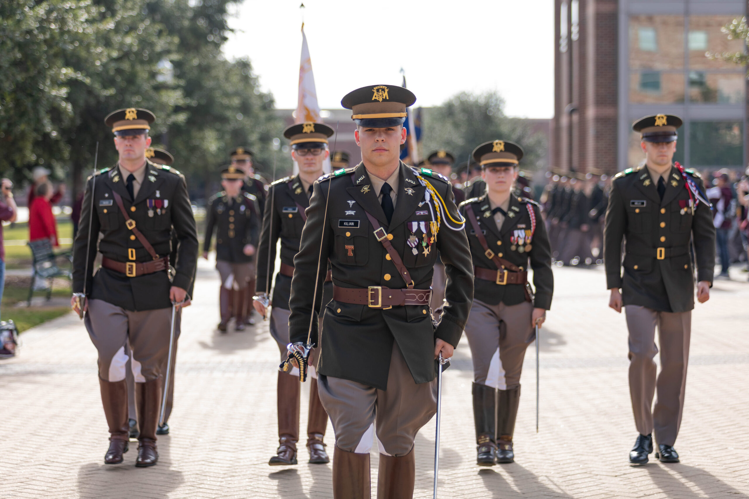 Cadets in uniform standing at attention. The five in the front are wearing their senior boots.