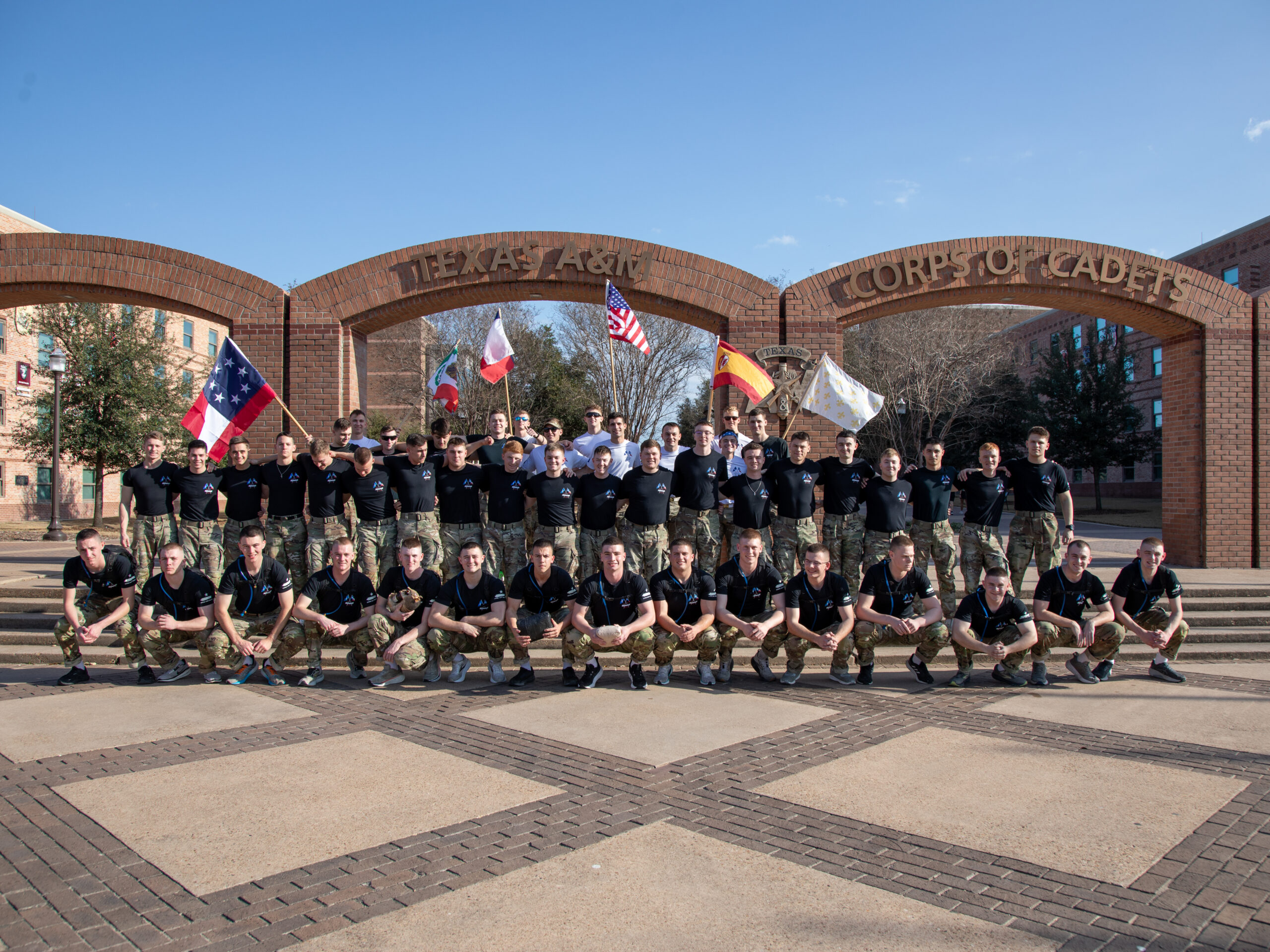 A group photo of cadets in front of the arches.