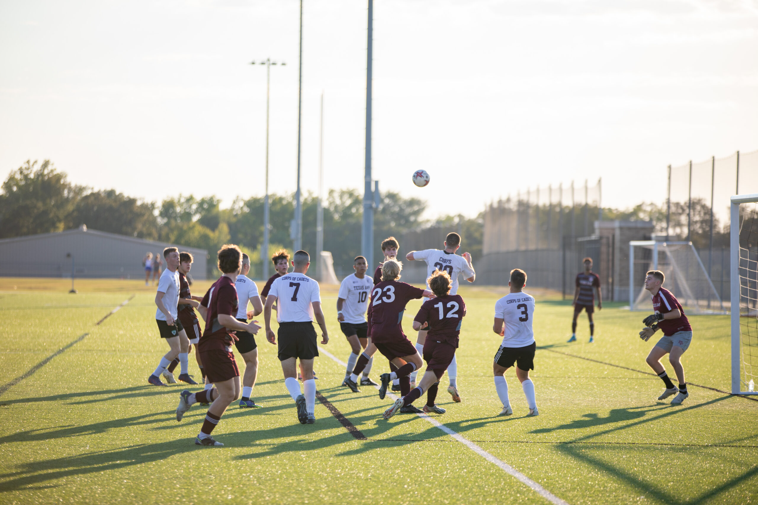 People playing soccer on a field.