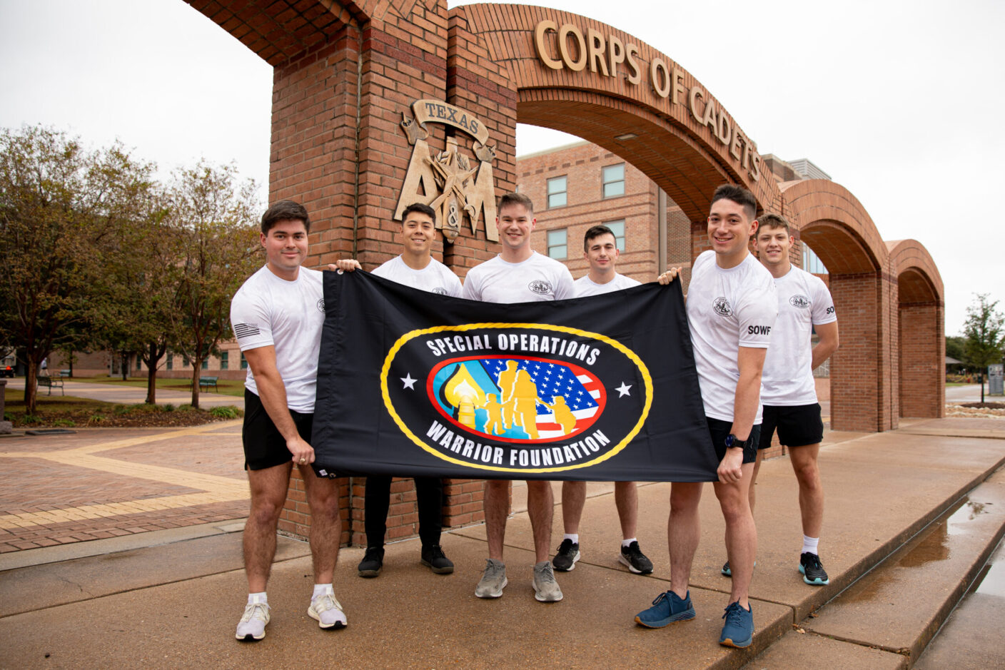 A group of six boys holding a flag.