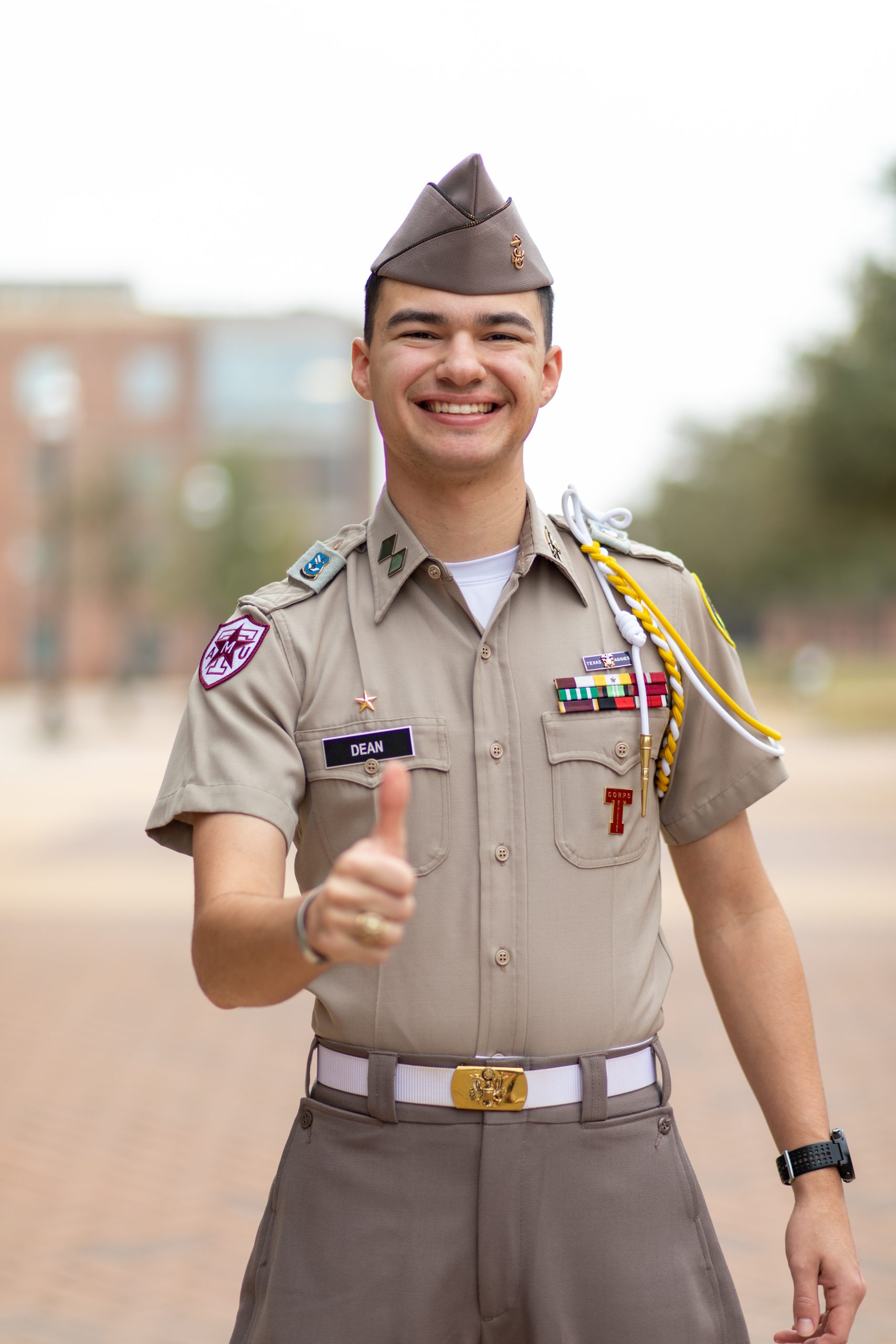 William Dean '23 gives a gig em on the Quad