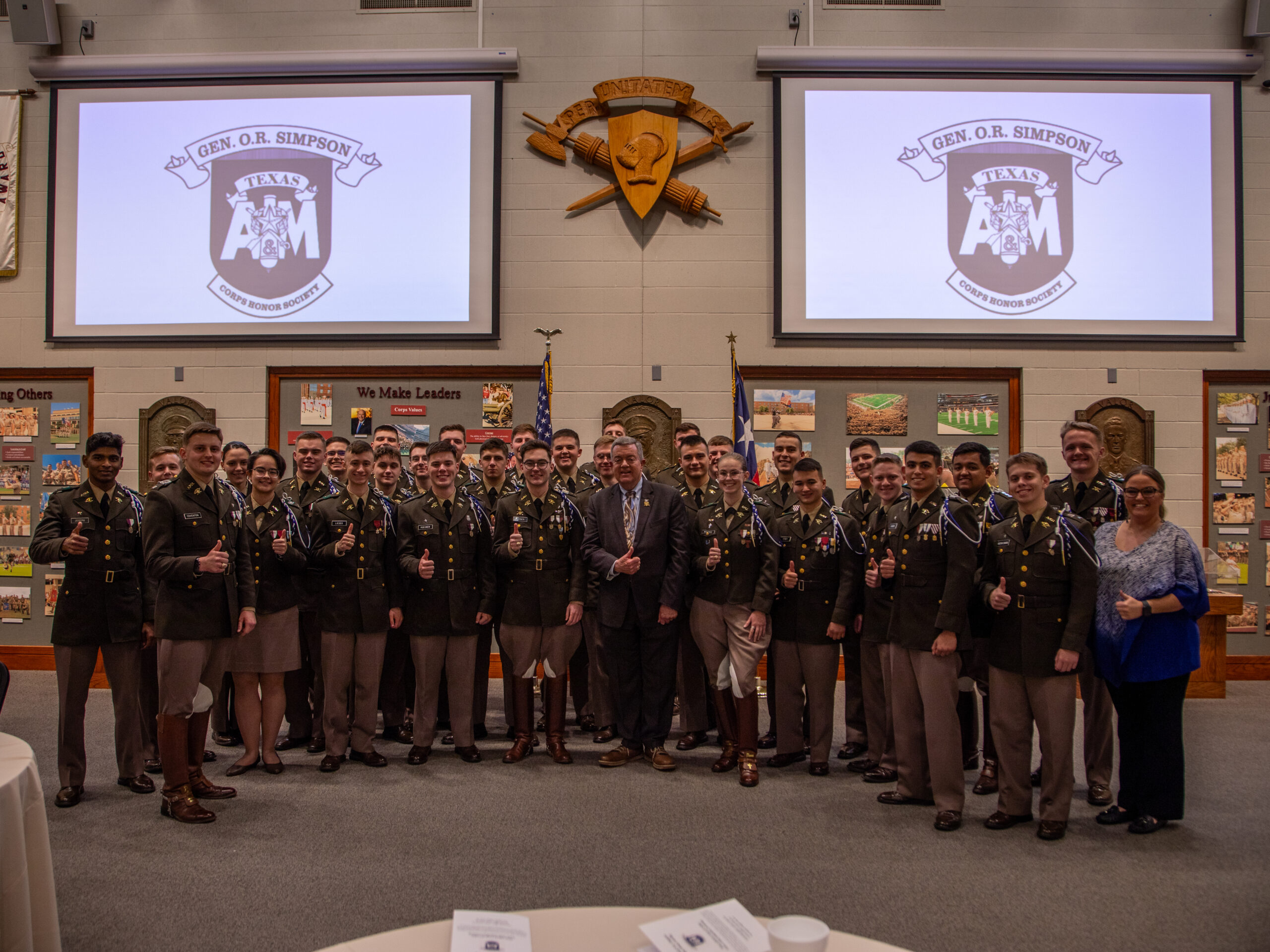 A group of cadets standing in front of a banner that says O.R. Simpson Induction Ceremony.