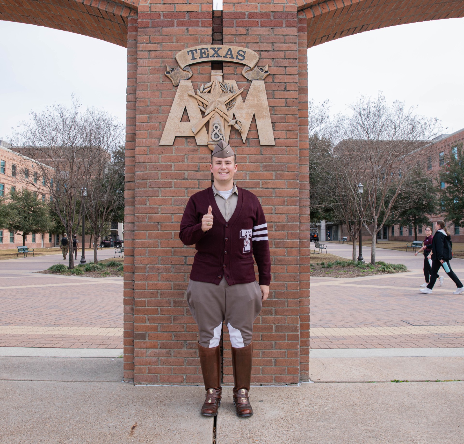 Cadet Mark Snyder smiles in front of the Quad arches.