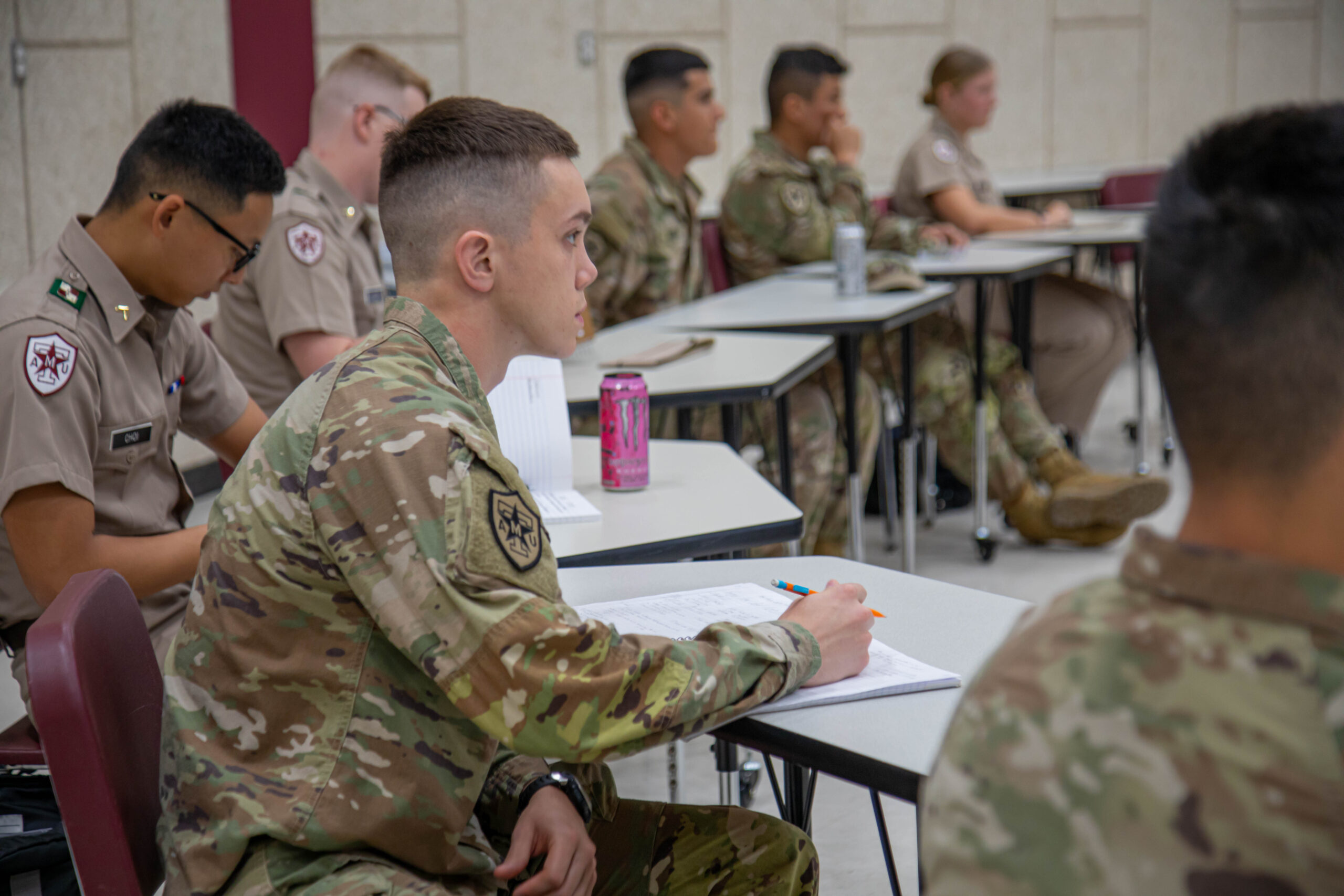 Cadets in a classroom taking notes.